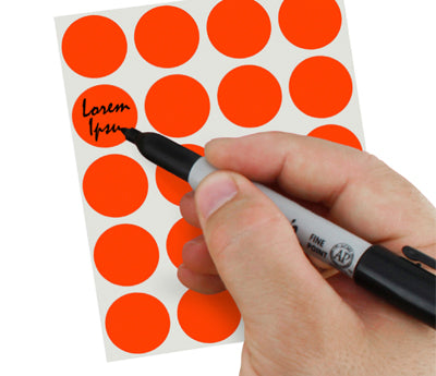 A Person's hand writing Lorem Ipsum on a sticker with a felt tip marker